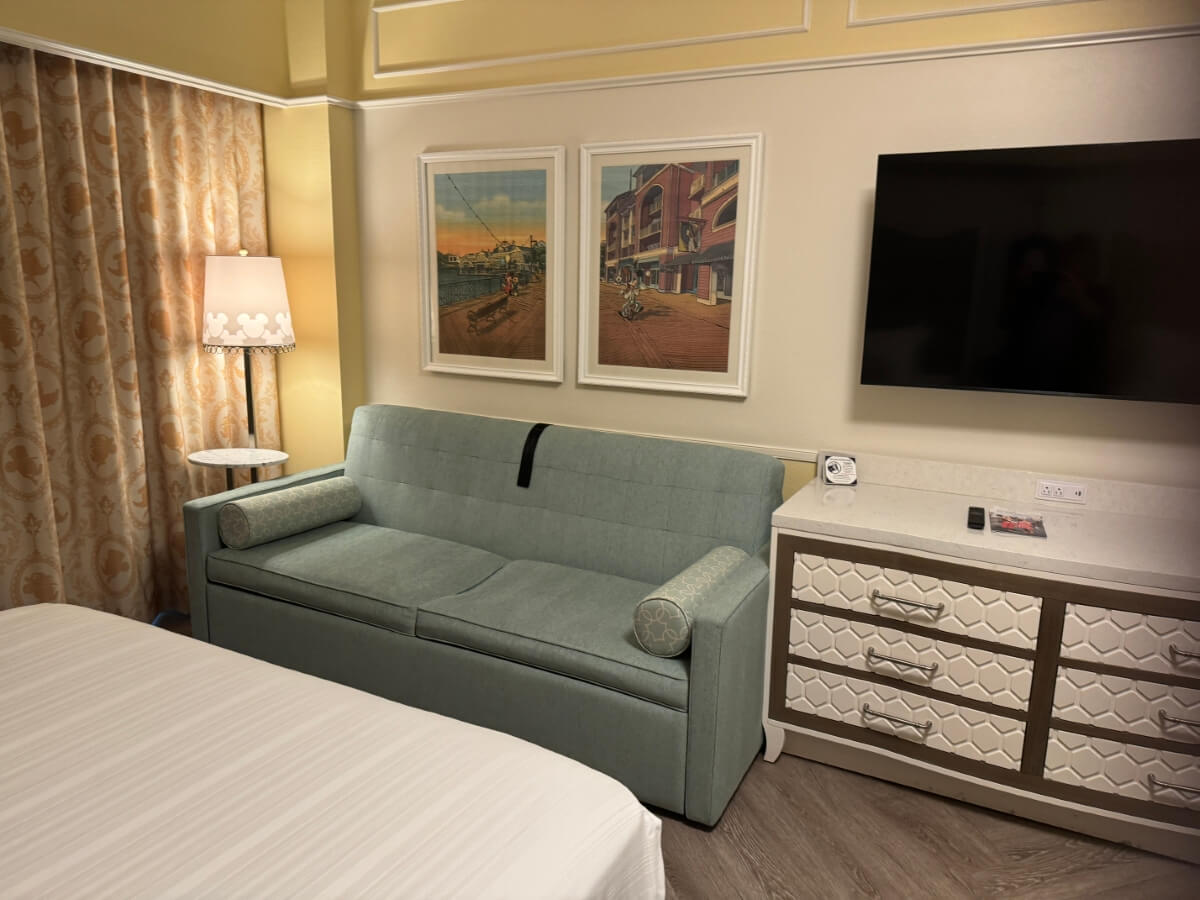 Boardwalk Inn Standard Room Couch, TV, and Dresser